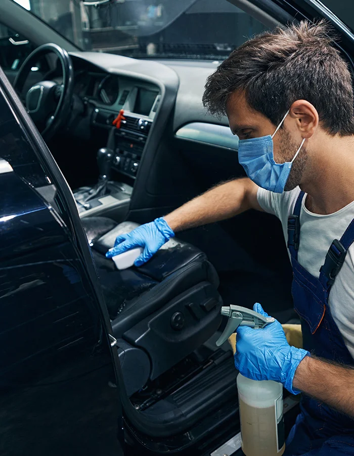 a-wroker-with-cleaner-wiping-car-seats